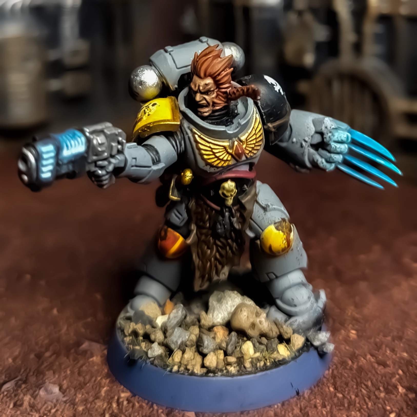 A photograph of a Space Wolves Blood Claw Pack Leader model, painted to a basic tabletop standard with added weathering effects.