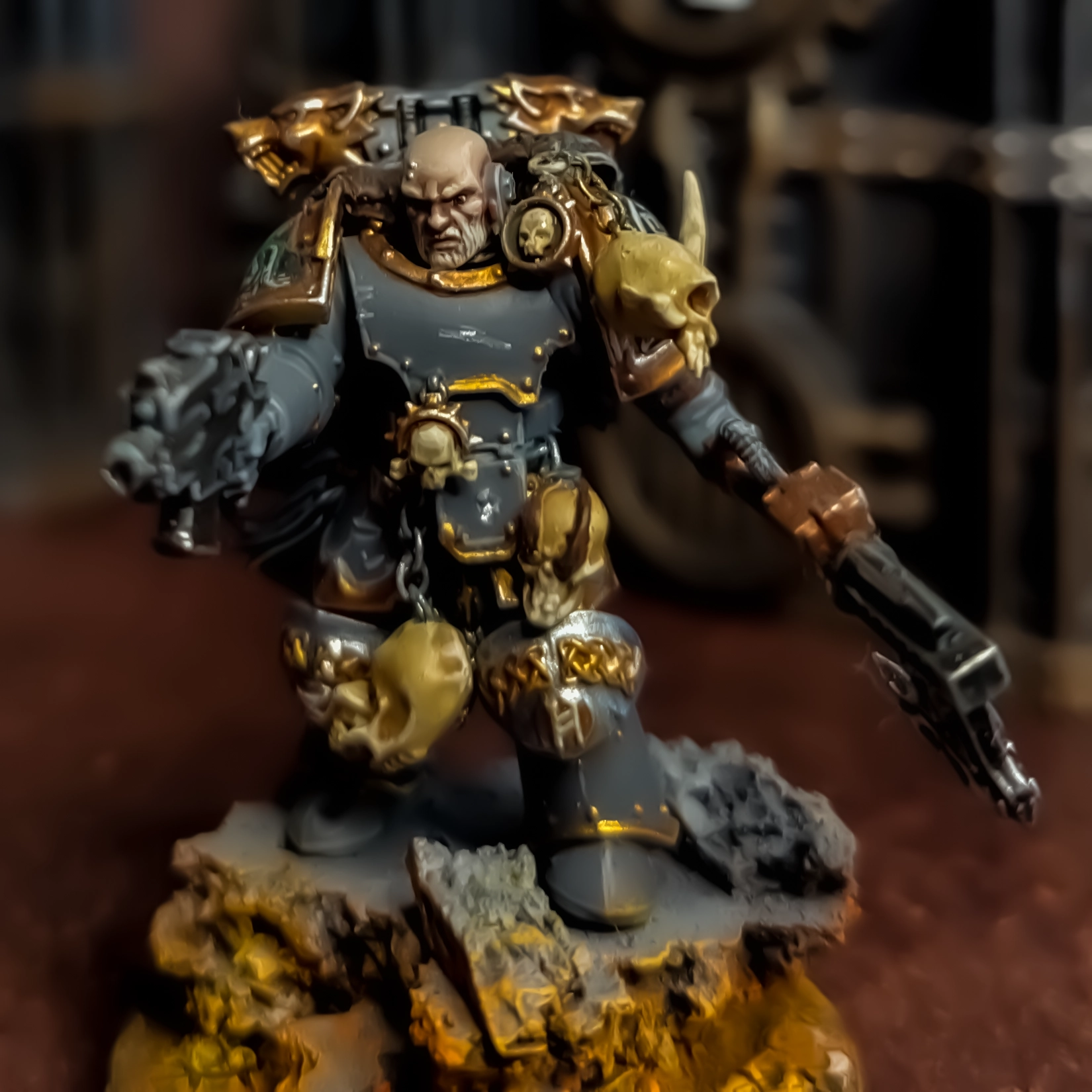 A conversion of several Chaos and Space Marine parts depicting a bald Space Wolves character wielding a black power axe and pointing a bolt pistol forward.