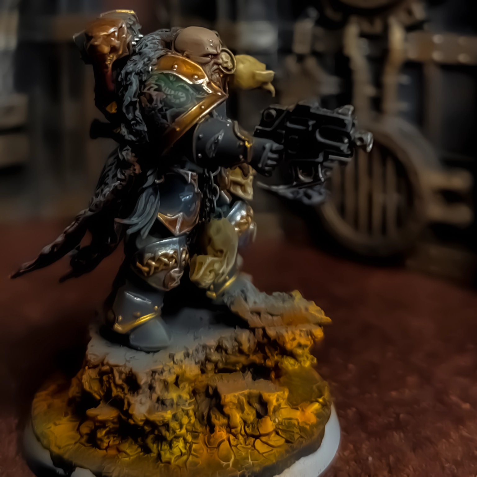 A conversion of several Chaos and Space Marine parts depicting a bald Space Wolves character wielding a black power axe and pointing a bolt pistol forward.