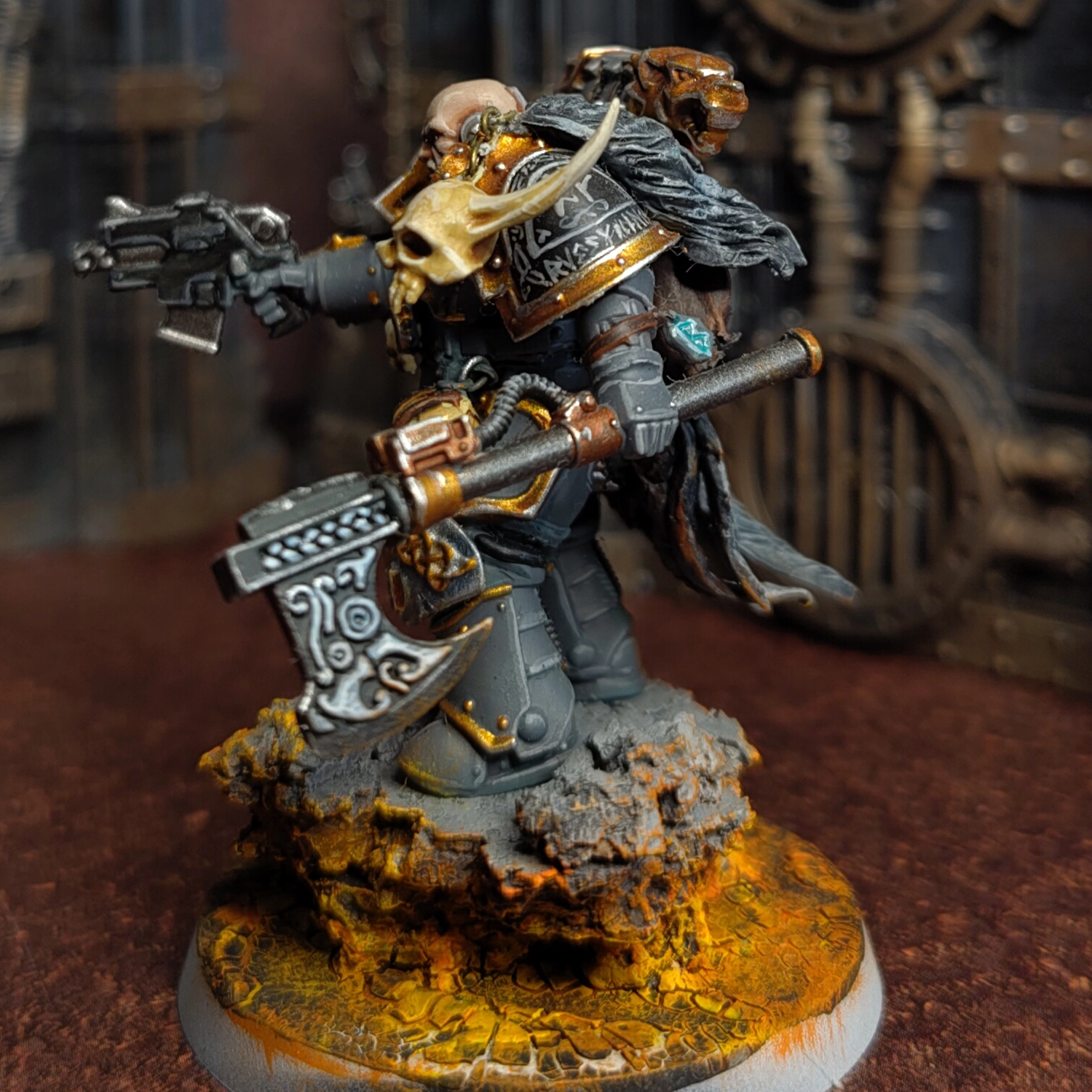 A conversion of several Chaos and Space Marine parts depicting a bald Space Wolves character wielding a black power axe and pointing a bolt pistol forward.