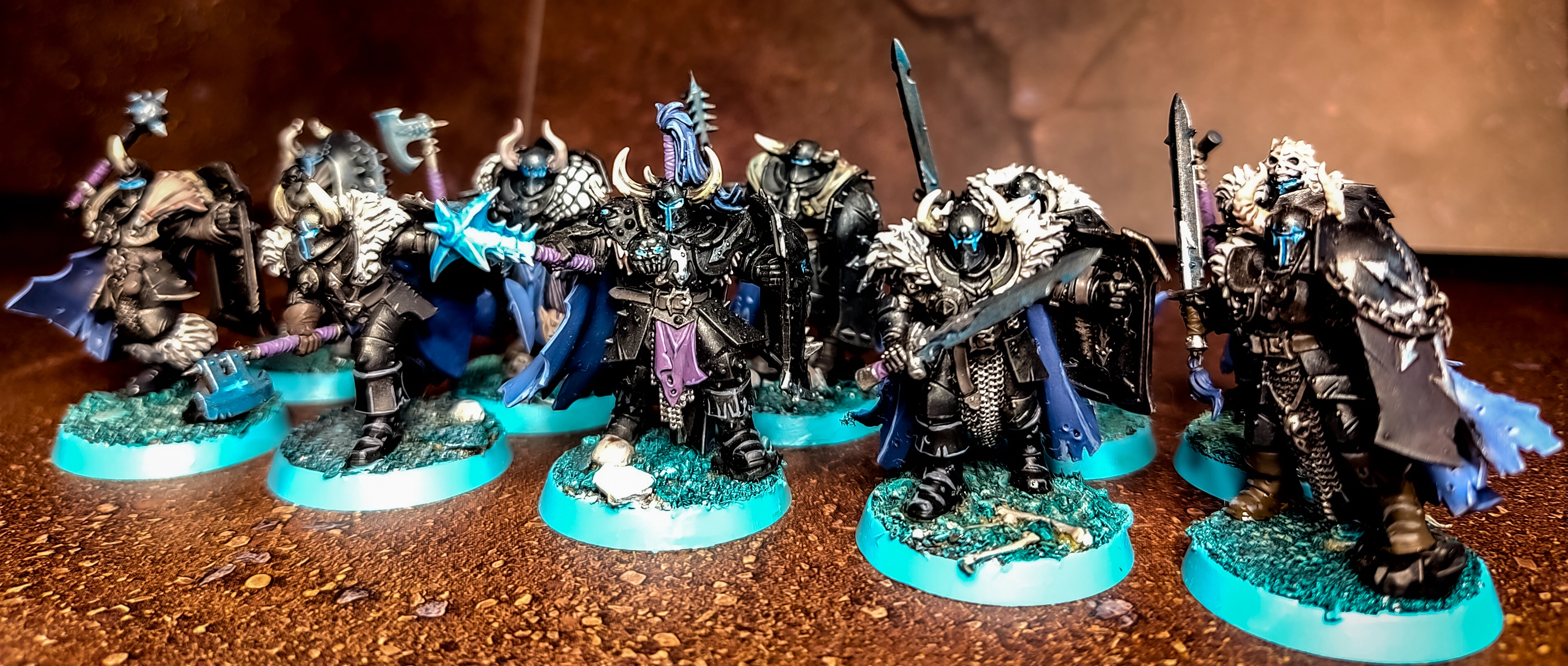 Chaos Warriors on ice bases with black armour and blue accent colours. subtle glow effects.