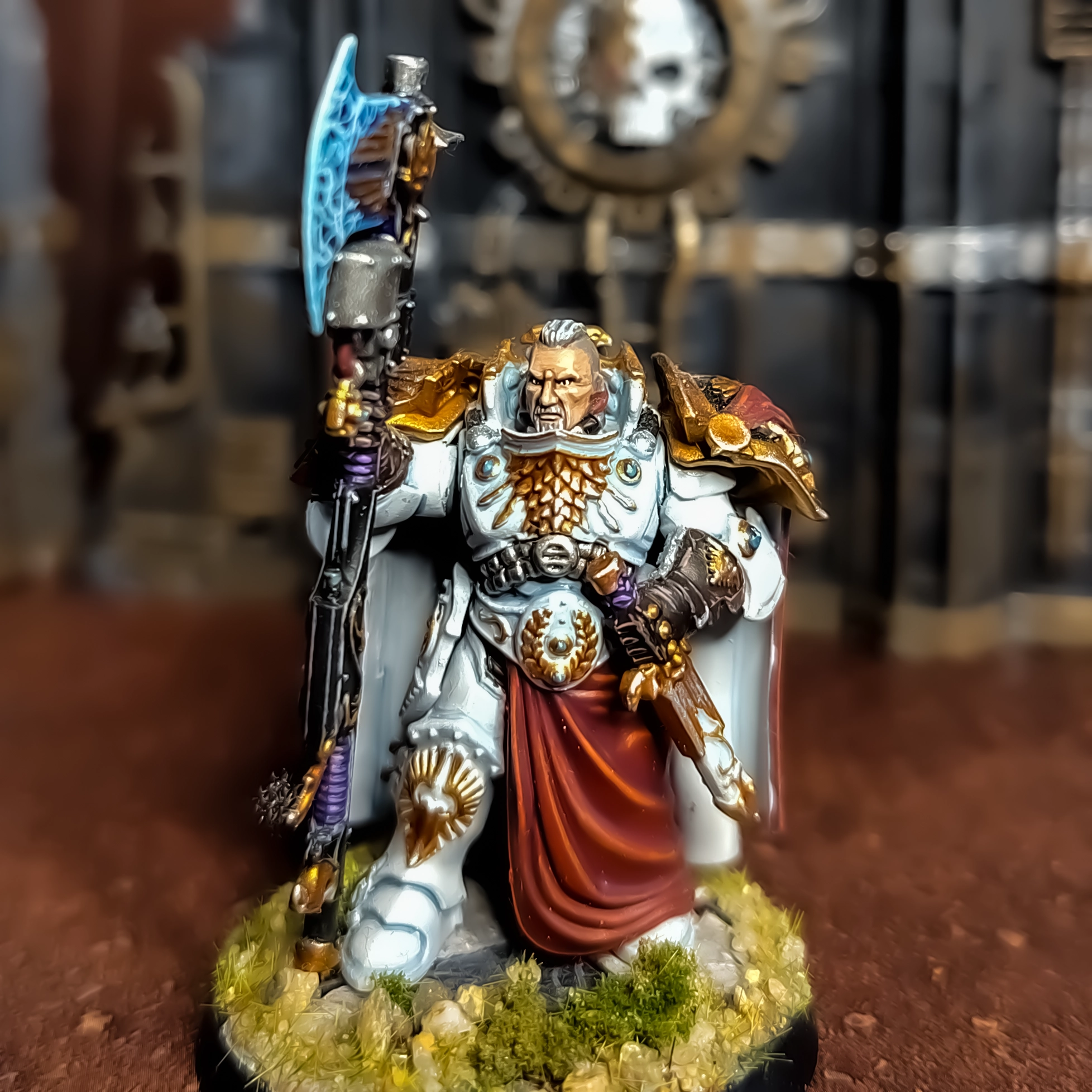 A photograph of a slightly converted Custodes Shield Captain painted to parade ready standard.